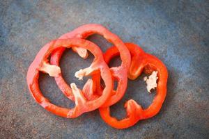 Red pepper bell on dark background , Top view - bell pepper sliced or fresh sweet pepper photo