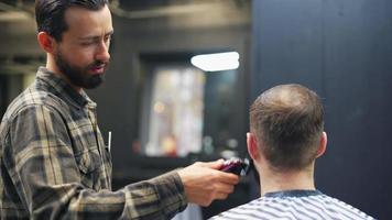 Barber combs and trims beard with electric trimmers video