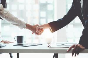 Business partnership meeting concept. Image business women handshake. Successful business people handshaking after good deal. Group support concept. photo