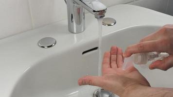 Unrecognisable man washing hands, close up video