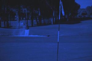 golfer hitting a sand bunker shot photo