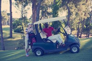 couple in buggy on golf course photo