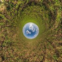 blue sky ball in middle of swirling asphalt road or field. Inversion of tiny planet transformation of spherical panorama 360 degrees. Spherical abstract view. Curvature of space. photo