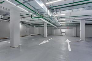empty underground garage parking with columns and road markings photo