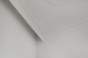 Detail of corner ceiling cornice with intricate crown molding. photo