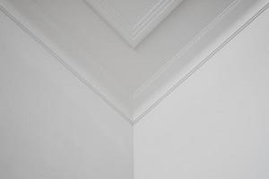 Detail of corner ceiling cornice with intricate crown molding. photo