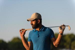 golfer  portrait at golf course on sunset photo