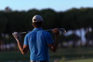 golfer from back at course looking to hole in distance photo