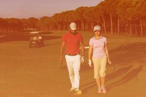 couple walking on golf course photo