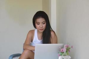 new normal, a businesswoman using computer to work for a company Via the internet on your desk at home. photo