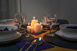 served table with cutlery and candles in interior of modern luxure guest room in studio apartments.  intimate atmosphere photo