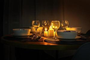 served table with cutlery and candles in interior of modern luxure guest room in studio apartments.  intimate atmosphere photo