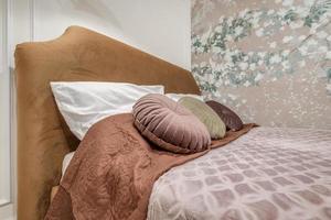 Interior of modern luxure bedroom in studio apartments in light pink color style photo