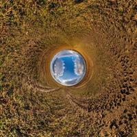 blue sky ball in middle of swirling sand road. Inversion of tiny planet transformation of spherical panorama 360 degrees. Curvature of space. photo