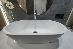 metal water tap with sink and faucet to turn on and regulate cold or hot water in expensive bathroom. photo