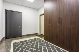 empty corridor for room in interior of modern apartments, office or clinic with many metal doors photo
