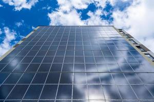 solar panels on the wall of a multi-storey building. Renewable solar energy. photo