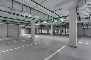 empty underground garage parking with columns and road markings photo