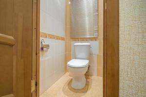 toilet and detail of a corner shower cabin with wall mount shower attachment photo