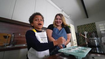 Young girl and adult woman in kitchen preparing food4k 29fp video