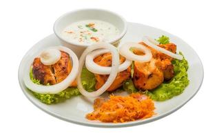 Chicken Tikka on the plate and white background photo