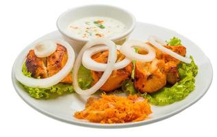 Chicken Tikka on the plate and white background photo