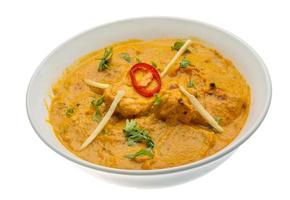 Butter chicken in a bowl on white background photo