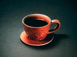 The earthenware cup of coffee. Close up photo