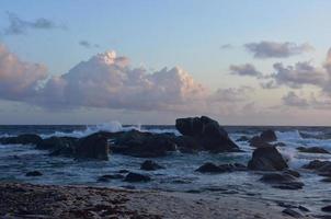 Pale Pink Clouds Over Rock Formations in Aruba photo