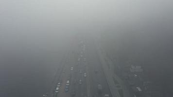 Cars travel on foggy road near Dnieper River in Kyiv, Ukraine video