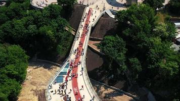 Aerial view of Kyiv pedestrian bridge over street traffic and view of city of Kyiv Ukraine video