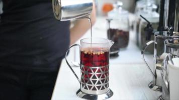 French press pushed down after loose leaf tea is steeped in hot water video