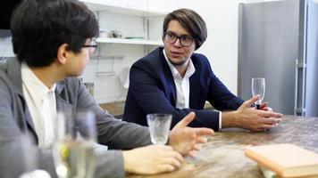 Workers in suits drink and talk video