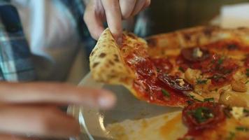 Hand taking pizza slice video