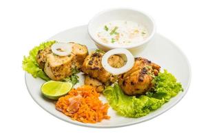 Chicken Tikka on the plate and white background photo