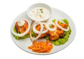 Chicken Tikka on the plate and white background photo