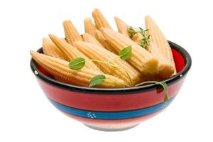 Baby corn in a bowl on white background photo