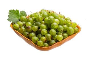 Gooseberry in a bowl on white background photo