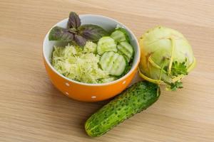 Kohlrabi salad on wooden background photo