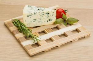 Blue cheese on wooden background photo
