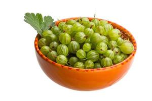 Gooseberries in a bowl on white background photo