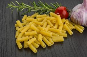 Penne on wooden background photo