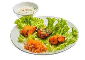 Fish Tikka on the plate and white background photo