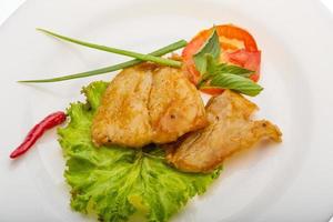 Baracuda steak on the plate and white background photo