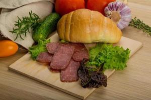 Salami on wooden plate photo