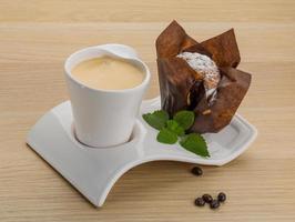 Coffee with muffin on wooden background photo