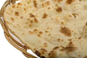 Plain Naan in a basket on white background photo