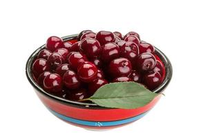 Cherry in the bowl on white background photo