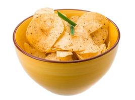 Potato chips in a bowl on white background photo