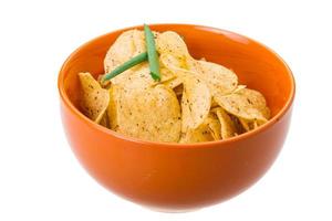 Potato chips in a bowl on white background photo